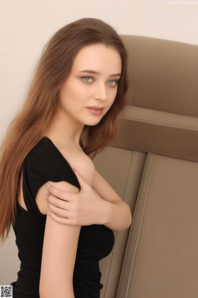 A woman in a black dress posing for a picture.